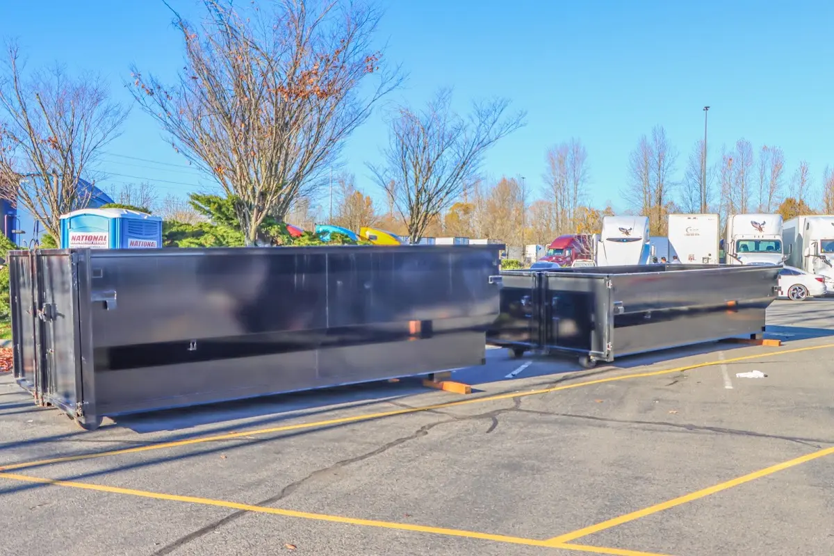 Professional dumpster rental service with roll-off container on residential driveway in St. Martin